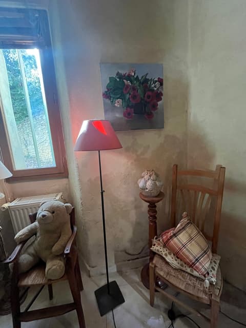 Red lamp and artwork in dining room corner