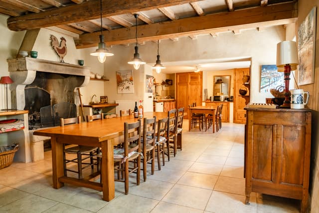 Dining room with a long wooden table and pendant lights