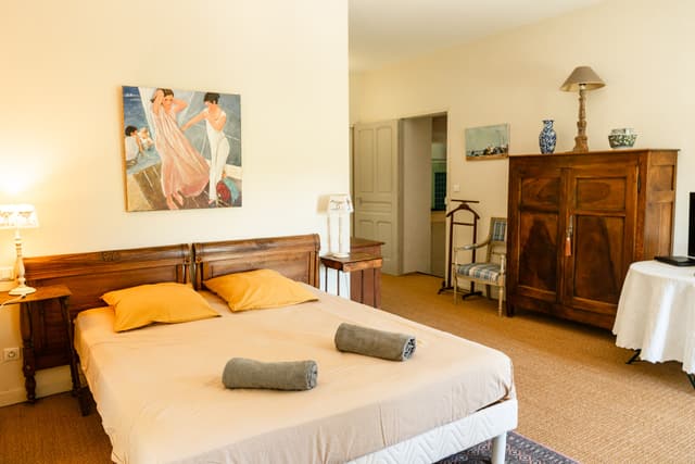 Master bedroom with a double bed and colorful artwork